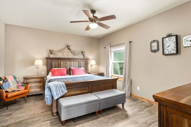 bedroom featuring baseboards, ceiling fan, and light wood-style floors