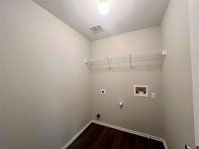 washroom featuring gas dryer hookup, hookup for a washing machine, dark wood-type flooring, and hookup for an electric dryer