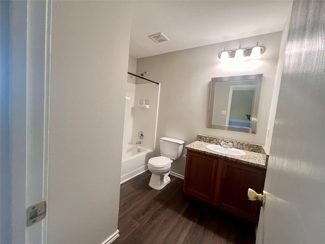 full bathroom with vanity, wood-type flooring, tub / shower combination, and toilet