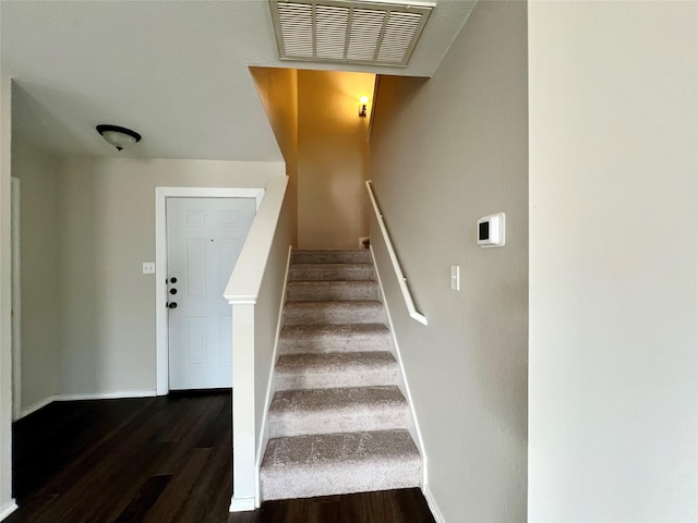 staircase featuring hardwood / wood-style floors