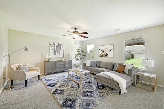 carpeted living room with ceiling fan