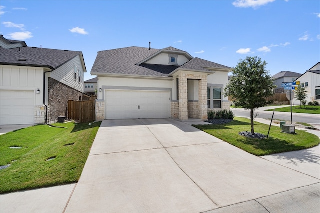 view of front facade with a garage, driveway, a front lawn, and stucco siding