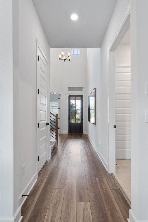 entrance foyer featuring a notable chandelier and dark wood-type flooring