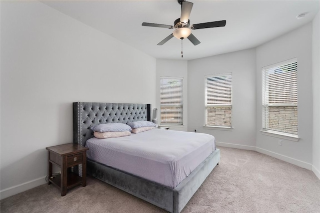 bedroom with light colored carpet and ceiling fan