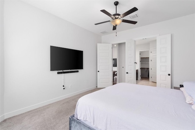 bedroom with light carpet, a ceiling fan, visible vents, and baseboards