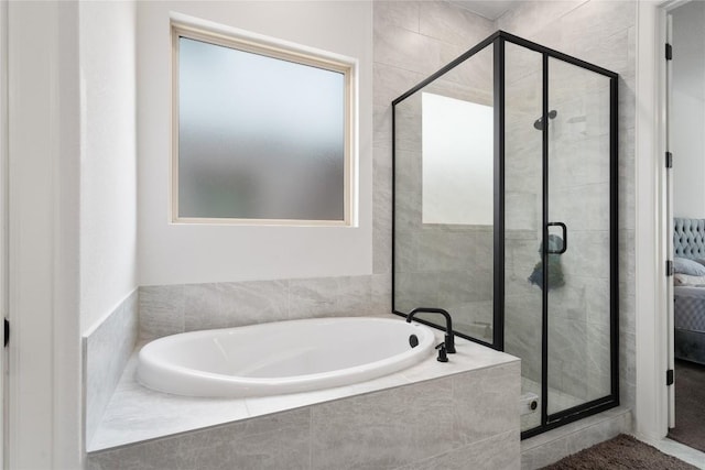 full bath featuring a stall shower and a garden tub