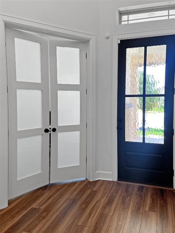 entryway featuring dark wood-type flooring and french doors