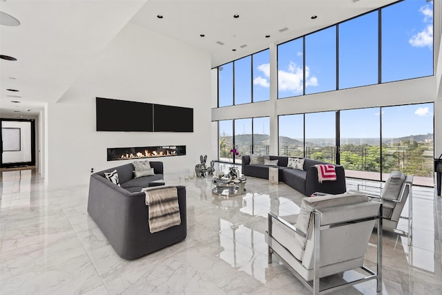 living room with a towering ceiling and light tile patterned flooring