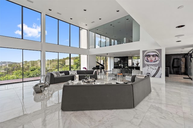 living room featuring light tile patterned floors and a towering ceiling