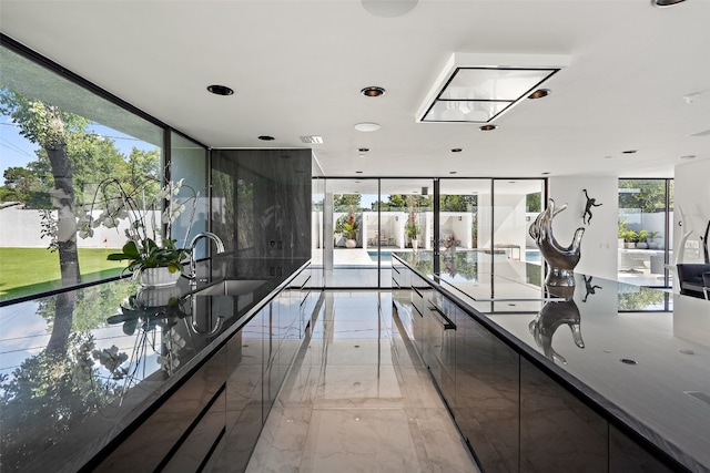 interior space with floor to ceiling windows and sink