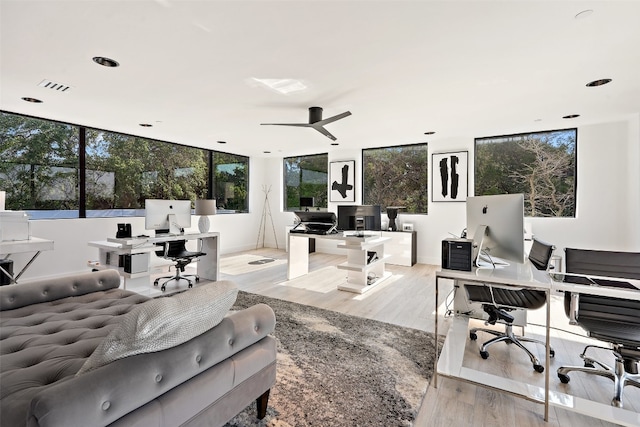 office area with light hardwood / wood-style flooring and ceiling fan