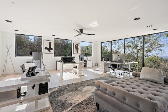 living room with light wood-type flooring and ceiling fan