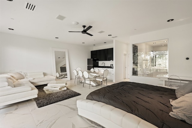 tiled bedroom with sink, ceiling fan, and black fridge