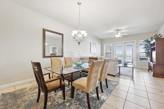 dining area with ceiling fan with notable chandelier and light tile patterned floors