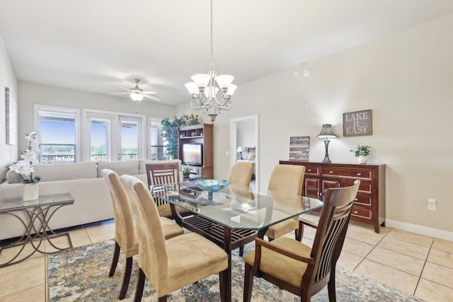 dining room with light tile patterned flooring and ceiling fan with notable chandelier