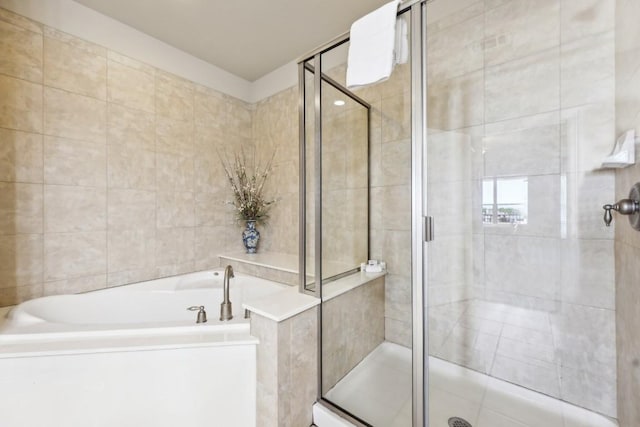 bathroom featuring plus walk in shower and tile walls