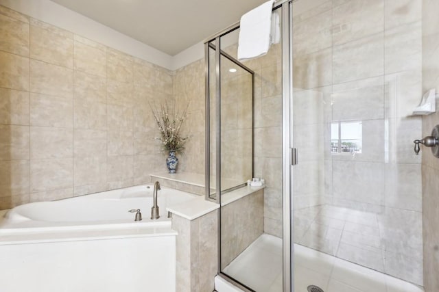 1000 The Cape Rd Unit 24, Horseshoe Bay, TX 78657 - full bathroom featuring a garden tub, a shower stall, and tile walls