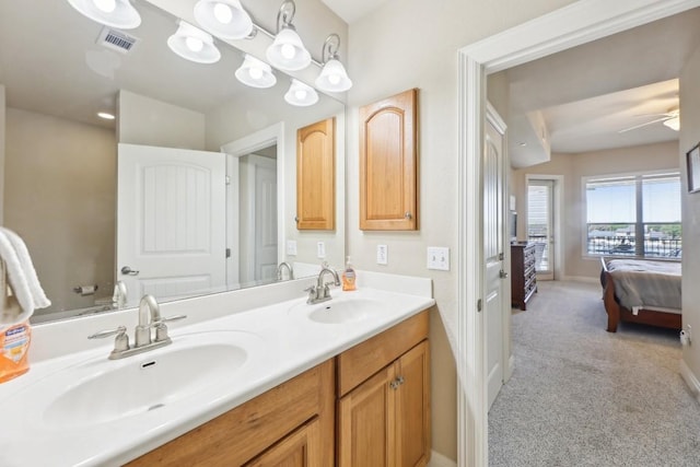 bathroom featuring ceiling fan and vanity