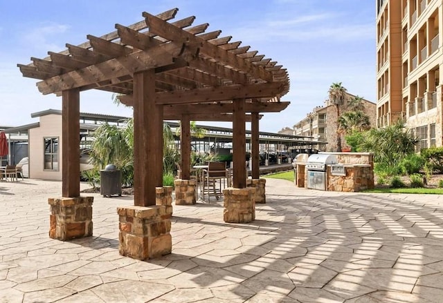 1000 The Cape Rd Unit 24, Horseshoe Bay, TX 78657 - view of patio / terrace featuring exterior kitchen and a pergola