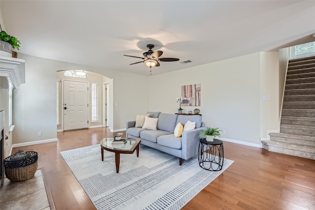 living room with wood-type flooring and ceiling fan