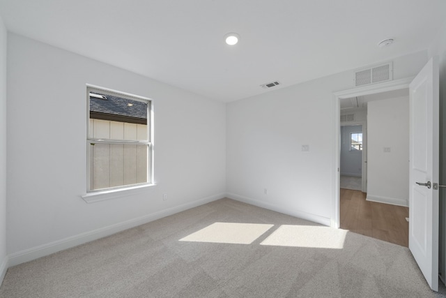 spare room with light colored carpet