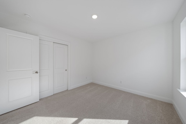 unfurnished bedroom featuring carpet floors and a closet