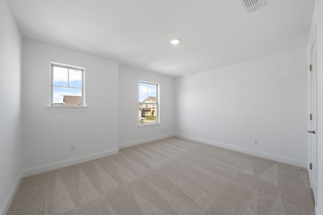 carpeted empty room featuring plenty of natural light