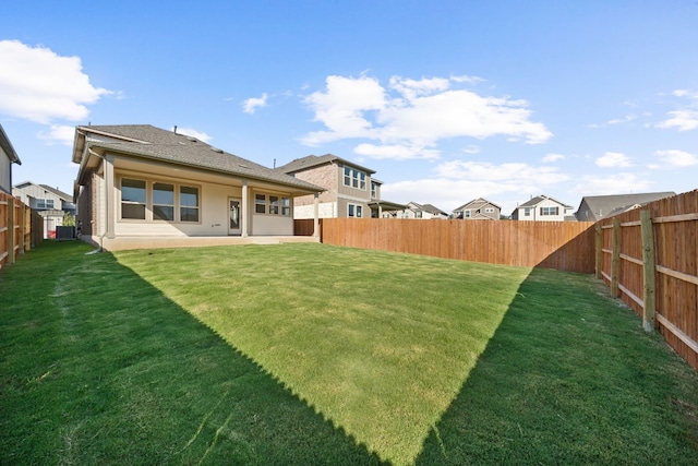 view of yard with cooling unit and a patio area