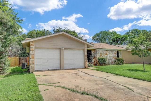 single story home with a garage, a front yard, and central AC unit