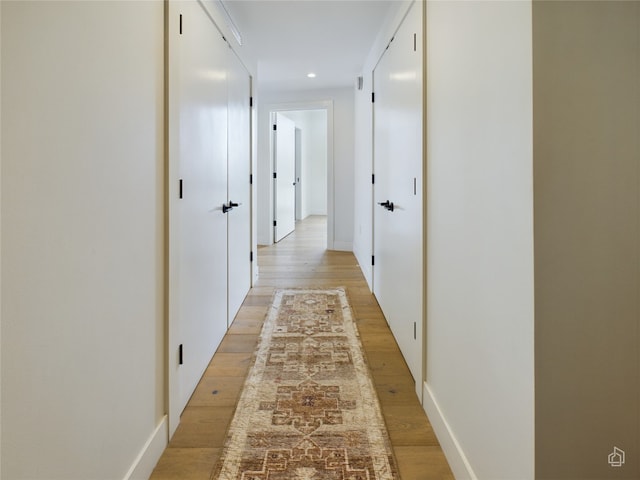 corridor featuring light hardwood / wood-style floors