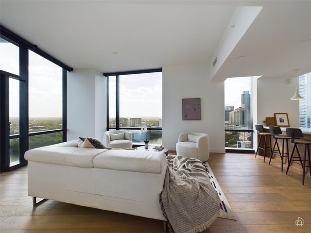 bedroom featuring wood-type flooring and floor to ceiling windows