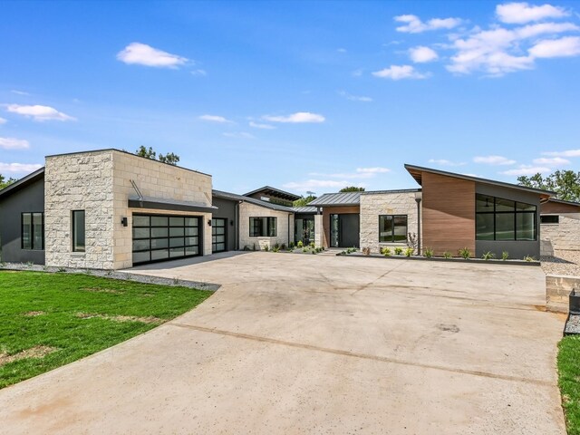 modern home featuring a garage and a front yard