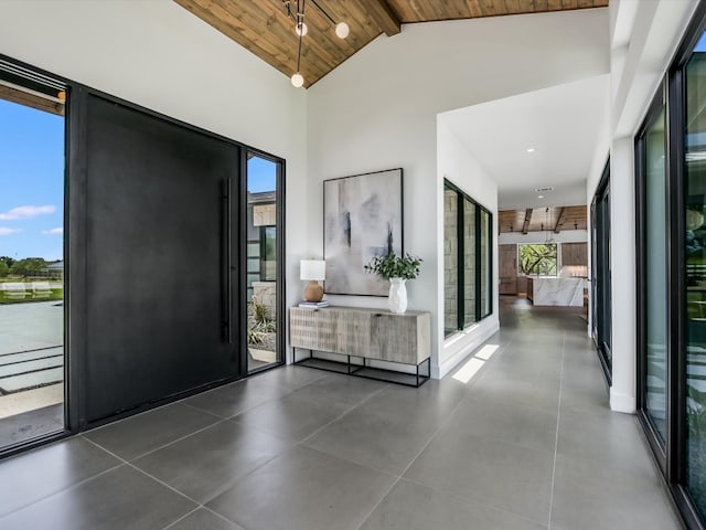 interior space featuring wood ceiling, high vaulted ceiling, and beam ceiling