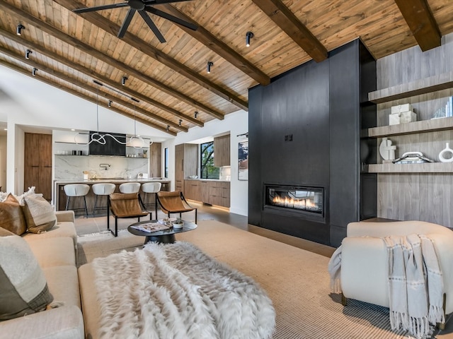 living room featuring beam ceiling, wood ceiling, ceiling fan, a fireplace, and high vaulted ceiling