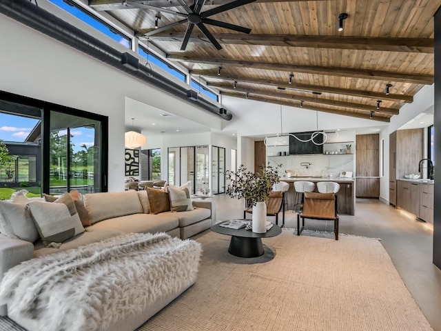 tiled living room with ceiling fan, beamed ceiling, wooden ceiling, sink, and high vaulted ceiling