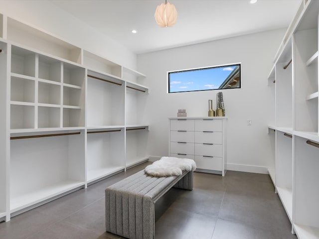 walk in closet featuring dark tile patterned flooring