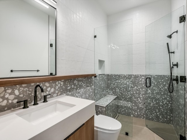 bathroom featuring a shower with shower door, tasteful backsplash, tile walls, toilet, and vanity