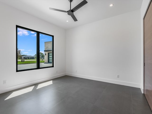 tiled empty room with ceiling fan