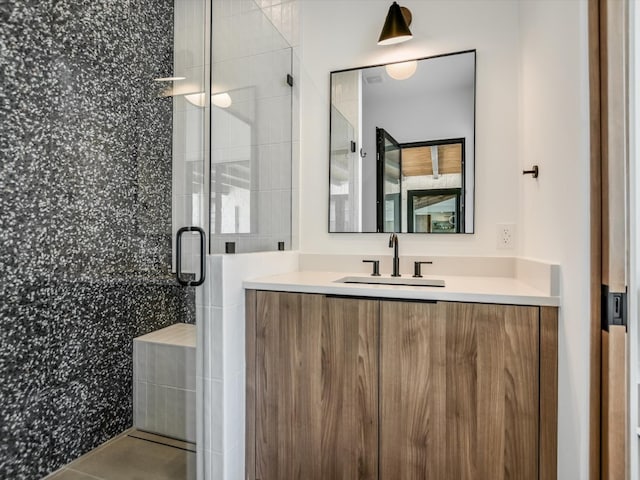 bathroom with walk in shower, tile patterned flooring, and vanity