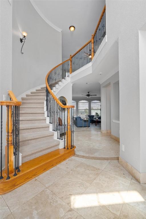 entrance foyer featuring ceiling fan and a high ceiling