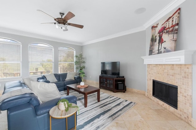 living room featuring ceiling fan, ornamental molding, a fireplace, and light tile patterned floors