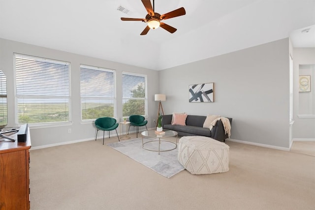 carpeted living room featuring vaulted ceiling and ceiling fan