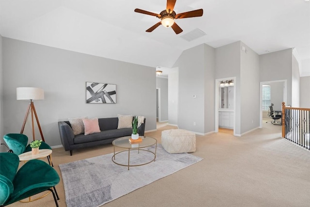 living room with vaulted ceiling, light carpet, and ceiling fan