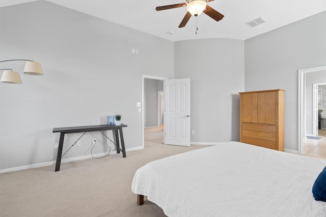 bedroom with ceiling fan, high vaulted ceiling, and light carpet