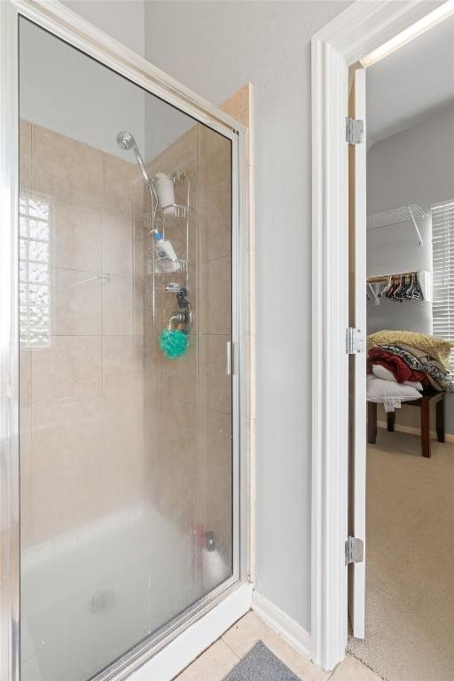 bathroom featuring a shower with shower door