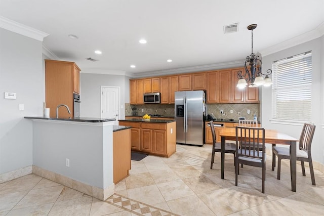 kitchen with sink, decorative light fixtures, kitchen peninsula, stainless steel appliances, and decorative backsplash