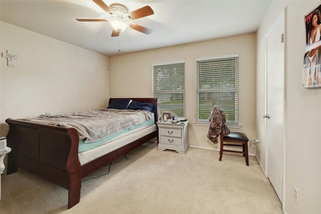 carpeted bedroom featuring ceiling fan