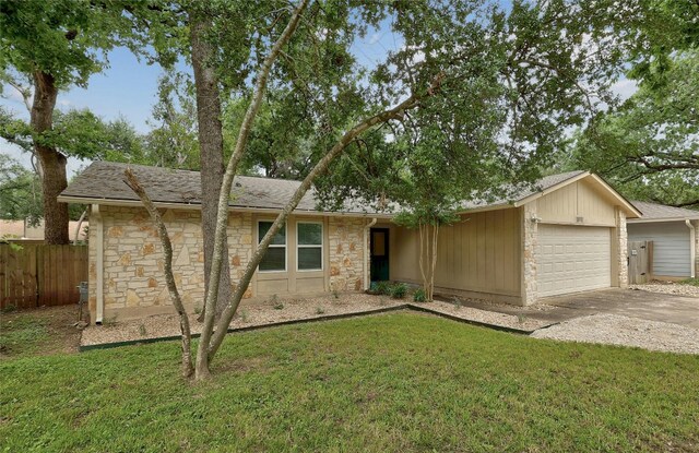 ranch-style home with a garage and a front yard