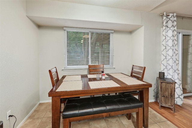 dining space with light hardwood / wood-style floors