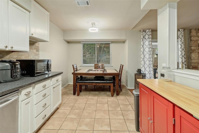 kitchen with white cabinetry, dishwasher, decorative backsplash, and light tile patterned floors